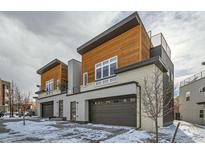 Two modern townhomes with wood siding and attached garages at 2804 W 53Rd Ave, Denver, CO 80221