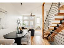 Bright living space featuring an open floor plan, hardwood floors and a staircase at 2680 Blake St # 12, Denver, CO 80205