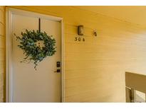 Inviting front door with a green decorative wreath and visible unit number, 304 at 12512 E Cornell Ave # 304, Aurora, CO 80014