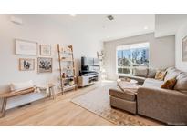 Bright living room with modern decor, large windows, and stylish furnishings at 3520 W Conejos Pl # 10, Denver, CO 80204
