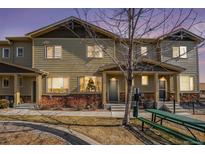 Charming townhome featuring stone accents, neutral siding, and a welcoming front entrance at 1631 Aspen Meadows Cir, Denver, CO 80260