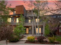 Contemporary home boasting stone accents, a landscaped yard, and a private balcony at 3841 Stuart St, Denver, CO 80212
