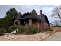 Charming two-story brick home featuring a classic design, well-kept landscaping, and inviting curb appeal at 2636 N Glencoe St, Denver, CO 80207