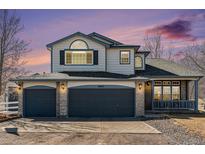 Charming two-story home with a three-car garage and beautiful exterior paint at 16651 Tree Haven St, Hudson, CO 80642