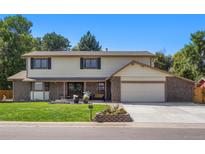 Charming two-story home with a well-manicured lawn, brick accents, and a spacious two-car garage at 5425 Camargo Rd, Littleton, CO 80123