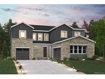 Inviting two-story home with stone and gray siding, featuring a two-car garage and manicured front lawn at 2537 Lupton Ln, Lafayette, CO 80026