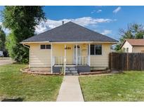 Charming single Gathering home featuring a yellow exterior and landscaped front yard at 109 6Th St, Fort Lupton, CO 80621