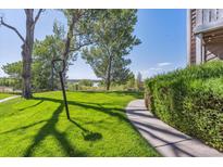 Landscaped backyard with a view of a lake at 4333 S Andes Way # 204, Aurora, CO 80015