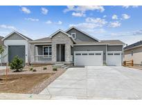 Charming home with a three-car garage, stone accents, manicured landscaping, and a welcoming front porch at 39161 Anthony St, Elizabeth, CO 80107