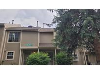 Inviting townhome featuring neutral siding, a covered front porch and well-maintained landscaping at 1818 S Quebec Way # 5-7, Denver, CO 80231