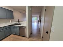 Galley-style kitchen with modern appliances and updated countertops and cabinets at 1818 S Quebec Way # 5-7, Denver, CO 80231