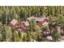 Stunning mountain home nestled among trees with multi-level decks and a separate guest house at 4618 Se Summit Trl, Evergreen, CO 80439