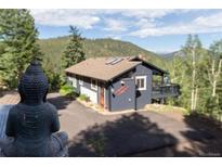 Mountain home featuring a charming exterior, a private driveway, and a zen garden at 20600 Rangeview Dr, Morrison, CO 80465