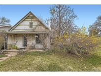 Cozy home exterior showcasing a quaint front porch, mature shrubs, and street view at 1824 S Logan St, Denver, CO 80210