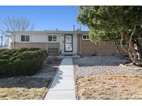 Charming single-story home with a well-maintained front yard and a welcoming walkway, in a quiet neighborhood at 6409 Brentwood St, Arvada, CO 80004