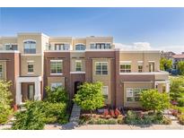 Inviting multi-level townhome with manicured front yard landscaping at 9158 Martin Luther King Blvd, Denver, CO 80238