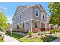 Charming two-story home with gray siding, brick accents, and a well-maintained front lawn at 5798 Biscay St, Denver, CO 80249