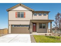 Charming two-story home features a two-car garage, tidy landscaping, and inviting front porch at 27460 E Cedar Pl, Aurora, CO 80018