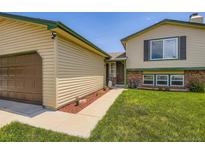 Charming two-story home with green lawn, a walkway to the front door, and a two-car garage at 3762 S Halifax St, Aurora, CO 80013