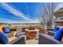 Inviting outdoor space with brick fire pit and comfortable seating, perfect for entertaining at 23593 E Eads Dr, Aurora, CO 80016