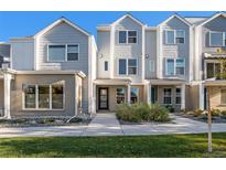 Attractive townhome with a well-maintained front yard and inviting entrance at 888 S Valentia St # 102, Denver, CO 80247