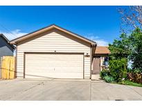 Charming single-Gathering home featuring a large two-car garage, neutral siding, and mature landscaping at 3296 S Bryant St, Englewood, CO 80110