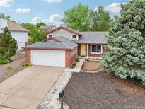 Charming single-Gathering home featuring a well-maintained yard, attached garage and inviting front door at 6337 W 68Th Pl, Arvada, CO 80003