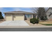 Charming single-story home boasting a stone facade, two-car garage, and well-maintained landscaping at 5480 Craftsman Dr, Parker, CO 80134