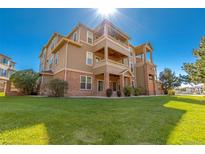 Attractive multi-story condo building with brick accents, multiple balconies, and well-maintained landscaping at 12760 Ironstone Way # 103, Parker, CO 80134