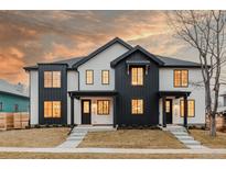 Modern farmhouse style home with black and white exterior and warm interior lighting at 4139 Benton Street, Denver, CO 80212