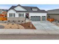 Beautiful two-story home featuring a three-car garage, modern design, and an inviting front yard at 1195 Melting Snow Way, Castle Rock, CO 80109