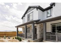 Charming two-story home with stone accents and a covered porch, offering curb appeal and outdoor living space at 5099 S Robb St, Littleton, CO 80127