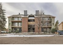 Traditional multi-Gathering home with brick accents, balconies, and mature trees offering a welcoming residential feel at 4899 S Dudley St # 17G, Littleton, CO 80123