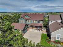 Charming two-story home with a well-maintained lawn and a classic brick-accented facade at 23427 Song Bird Hills Pl, Parker, CO 80138