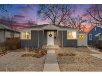 Charming gray single-story home with a well-maintained front yard and inviting entrance at dusk at 2424 S Humboldt St, Denver, CO 80210