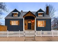 Charming home featuring updated siding, a quaint front porch, and a classic picket fence at 285 E Dartmouth Ave, Englewood, CO 80113