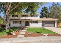 Charming two-story home with landscaped yard and attached garage at 6877 S Franklin Cir, Centennial, CO 80122