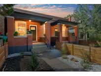 Charming brick duplex showcasing covered front porches and landscaped front yards with decorative white rock at 3329 N High St, Denver, CO 80205