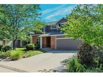 Two-story house with brick and siding, attached garage, and landscaped yard at 6515 S Killarney Ct, Aurora, CO 80016