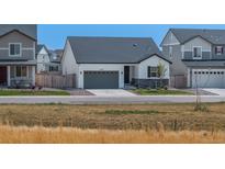Charming one-story home with gray garage door and stone accents at 27728 E 10Th Dr, Aurora, CO 80018