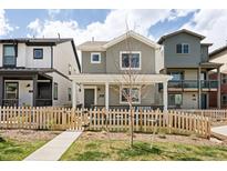 Charming two-story home with a picket fence and covered porch, perfect for relaxing and enjoying the neighborhood at 320 Marshall Mews, Superior, CO 80027
