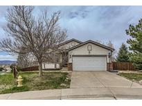 Charming single Gathering home featuring a driveway, two-car garage and mature landscaping at 815 Concho Ct, Castle Rock, CO 80104