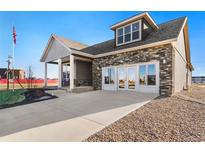 Beautiful single-Gathering home featuring stone accents, a covered porch, and a spacious driveway at 359 Josef Cir, Fort Lupton, CO 80621