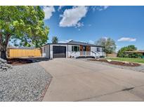 Charming one-story home featuring a spacious driveway and well-maintained front yard at 7826 Joan Dr, Denver, CO 80221