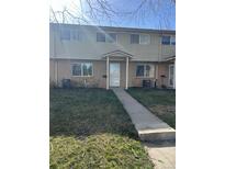 Two-story townhouse featuring a brick facade with a covered front porch at 4505 Everett St, Wheat Ridge, CO 80033