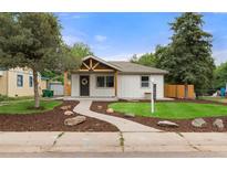 Charming home featuring a well-manicured lawn, welcoming walkway, and modern exterior design at 3287 S Humboldt St, Englewood, CO 80113