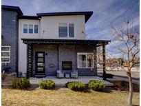 Modern two-story home with a stone facade, porch, fireplace and a manicured front yard at 3003 S Sherman St, Englewood, CO 80113