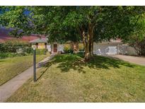 Charming single-Gathering home featuring a well-manicured lawn and mature trees providing ample shade at 291 Magnolia St, Denver, CO 80220