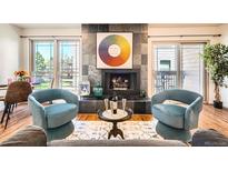 Inviting living room featuring a striking fireplace, modern furnishings, and plenty of natural light at 701 Harlan St # E59, Lakewood, CO 80214