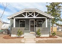 Charming bungalow with craftsman details, featuring a cozy front porch and a landscaped yard at 2200 Fenton St, Edgewater, CO 80214